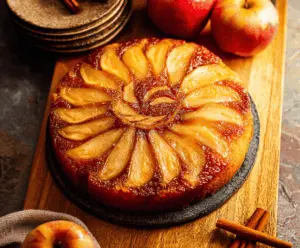 Delicious homemade apple upside down cake topped with caramelized apple slices and a golden brown crust, perfect for dessert or special occasions.