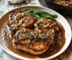 Juicy pork chops topped with savory pan gravy served on a plate, perfect for a hearty meal