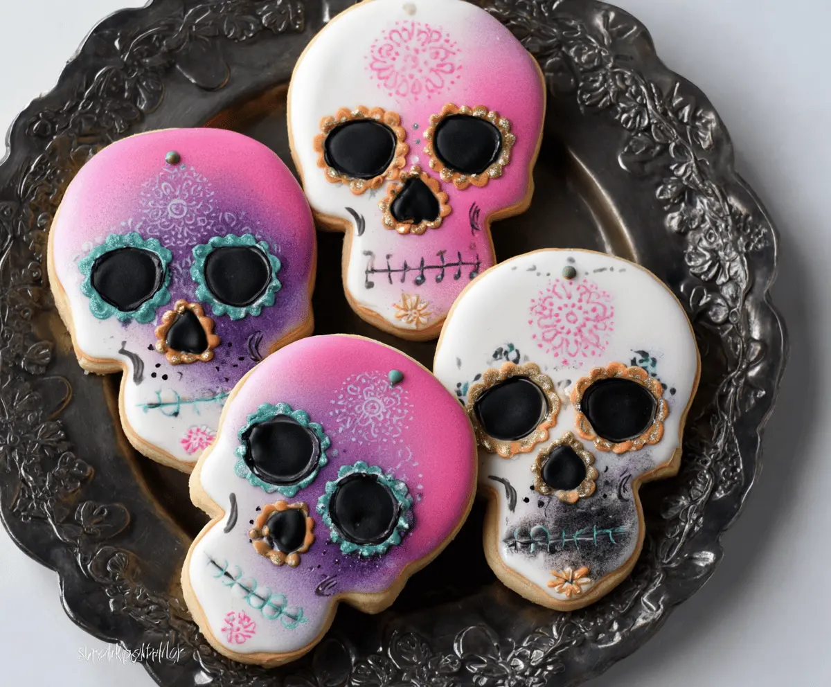 Colorful skull-shaped sugar cookies decorated with vibrant icing and intricate designs for a spooky Halloween treat