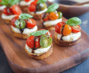 Delicious Caprese Bites with fresh cherry tomatoes, mozzarella, and basil on toothpicks.