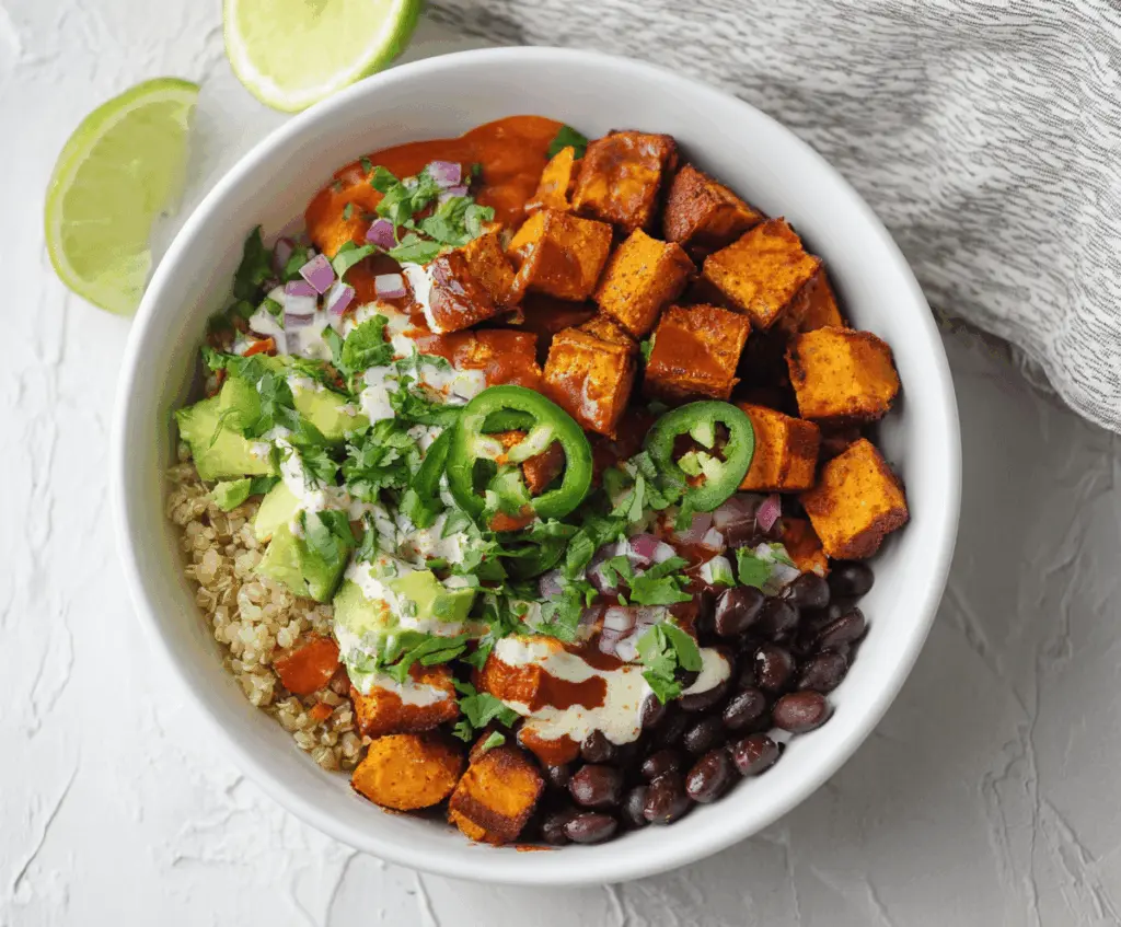 Colorful Chipotle Sweet Potato Burrito Bowl with black beans, avocado, and fresh cilantro for a healthy meal.