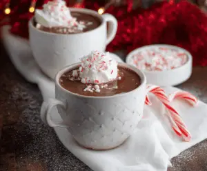Creamy Christmas Peppermint Hot Chocolate topped with whipped cream and crushed peppermint candies