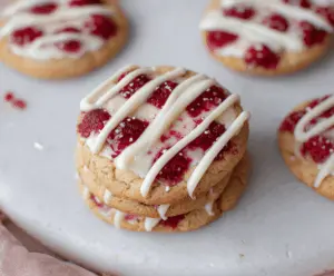 Delicious Crumbl Raspberry Cheesecake Cookies with fresh raspberries and creamy cheesecake filling.
