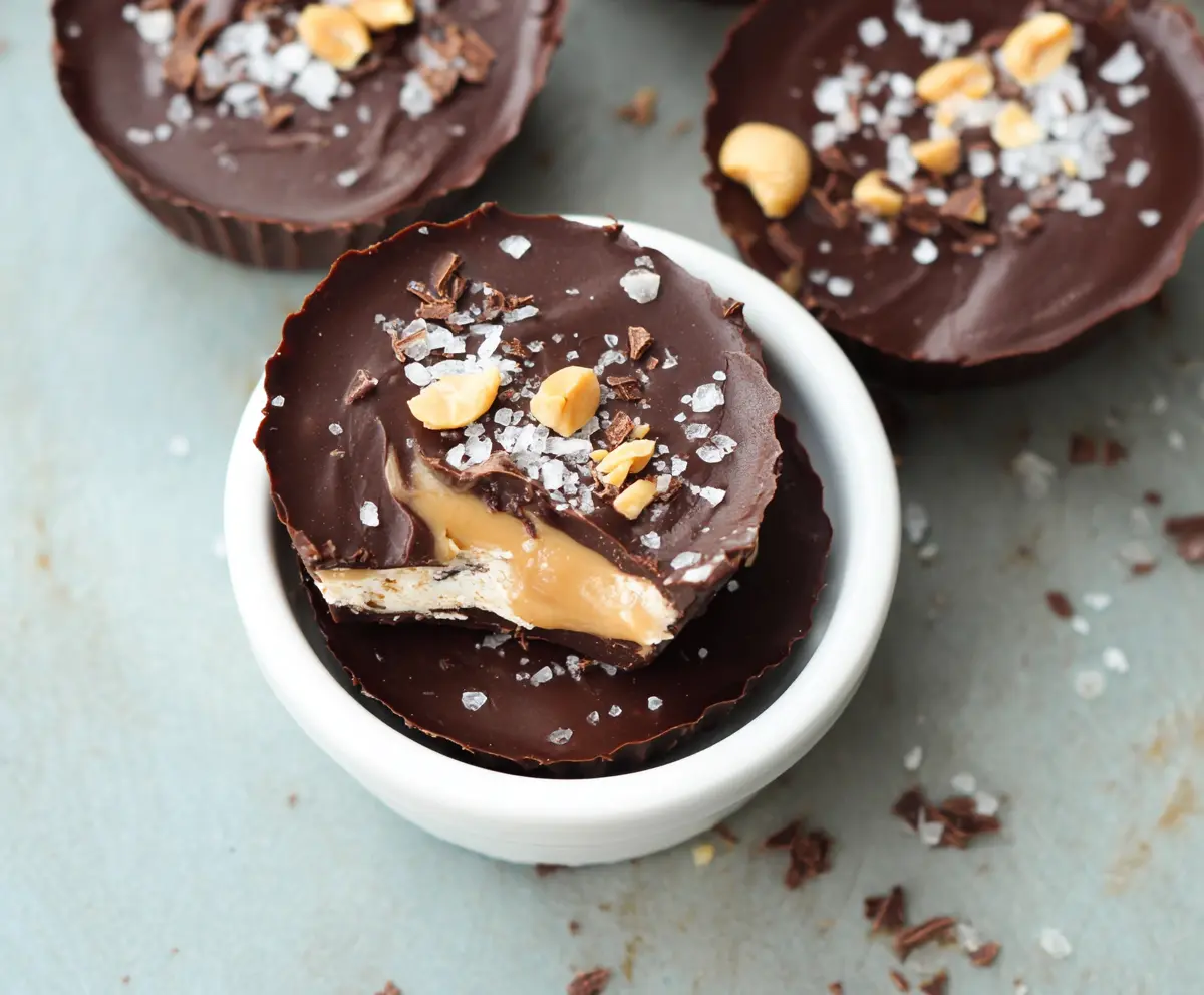Delicious Greek Yogurt Peanut Butter Cups on a plate with a drizzle of chocolate