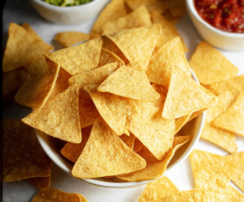 Crispy homemade tortilla chips served with salsa and guacamole