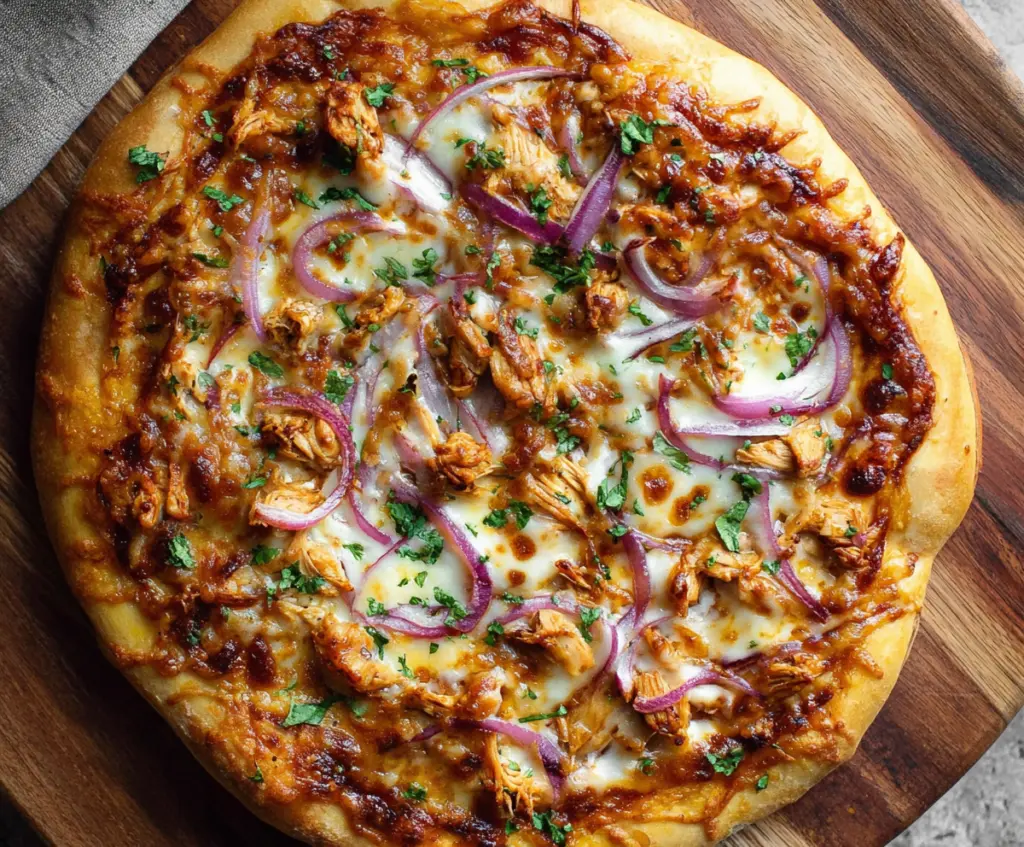 Delicious BBQ chicken pizza with melted cheese, grilled chicken pieces, and smoky barbecue sauce on a crispy crust.