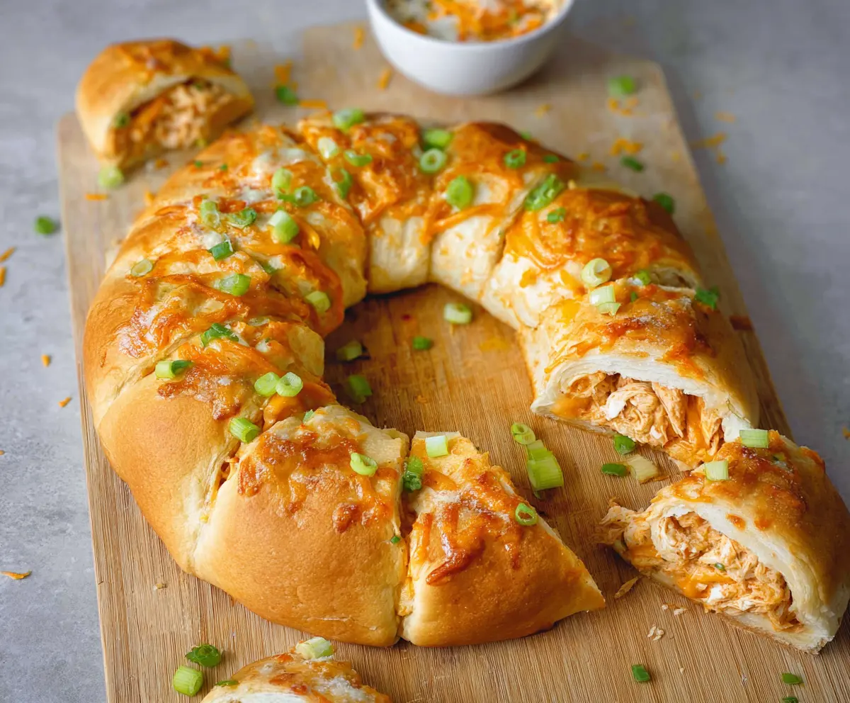 Baked Buffalo Chicken Crescent Roll Ring with crispy edges and flavorful filling on a serving platter.