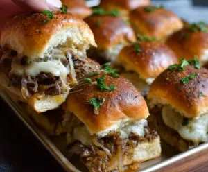 Savory French Onion Beef Sliders featuring caramelized onions and melted cheese on mini buns.
