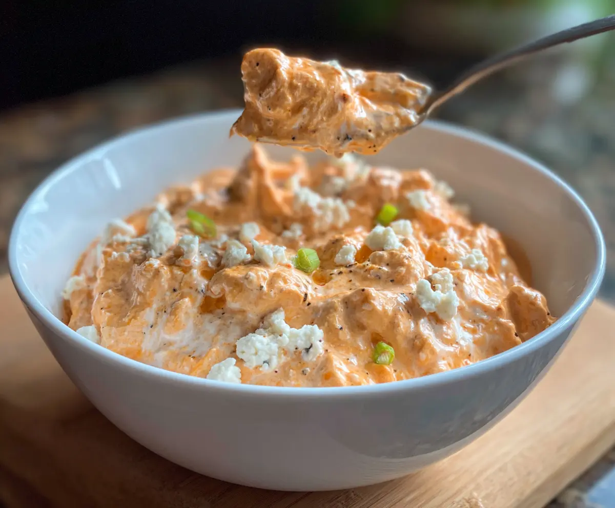 Healthy Buffalo Chicken Cottage Cheese dish with spicy sauce and fresh ingredients
