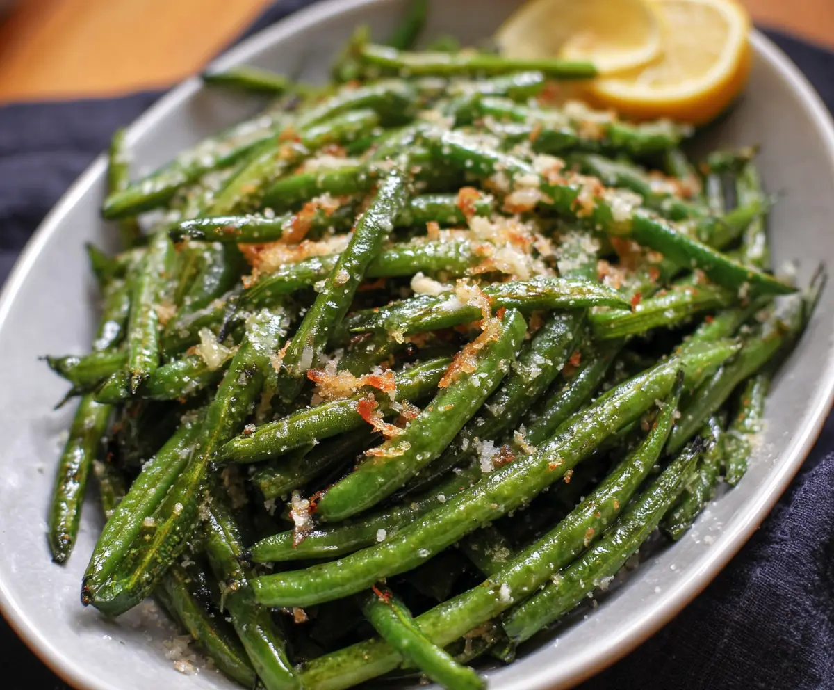 Fresh garlic Parmesan green beans cooked to perfection, garnished with cheese and herbs.