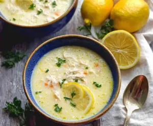 Creamy Greek Avgolemono Soup with lemon, chicken, and rice in a bowl.